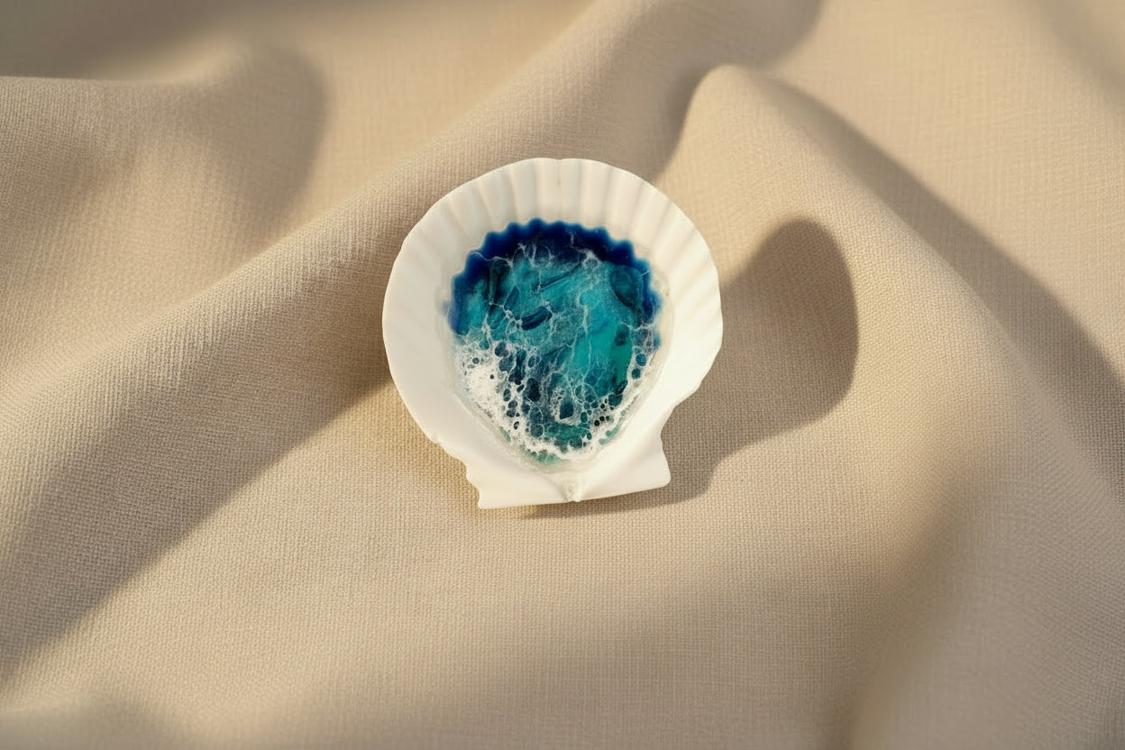 Shell with blue and white interior on a beige fabric background