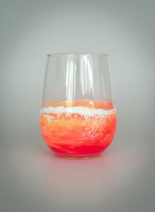 stemless wine glass with orange, pink and yellow sunset resin waves 