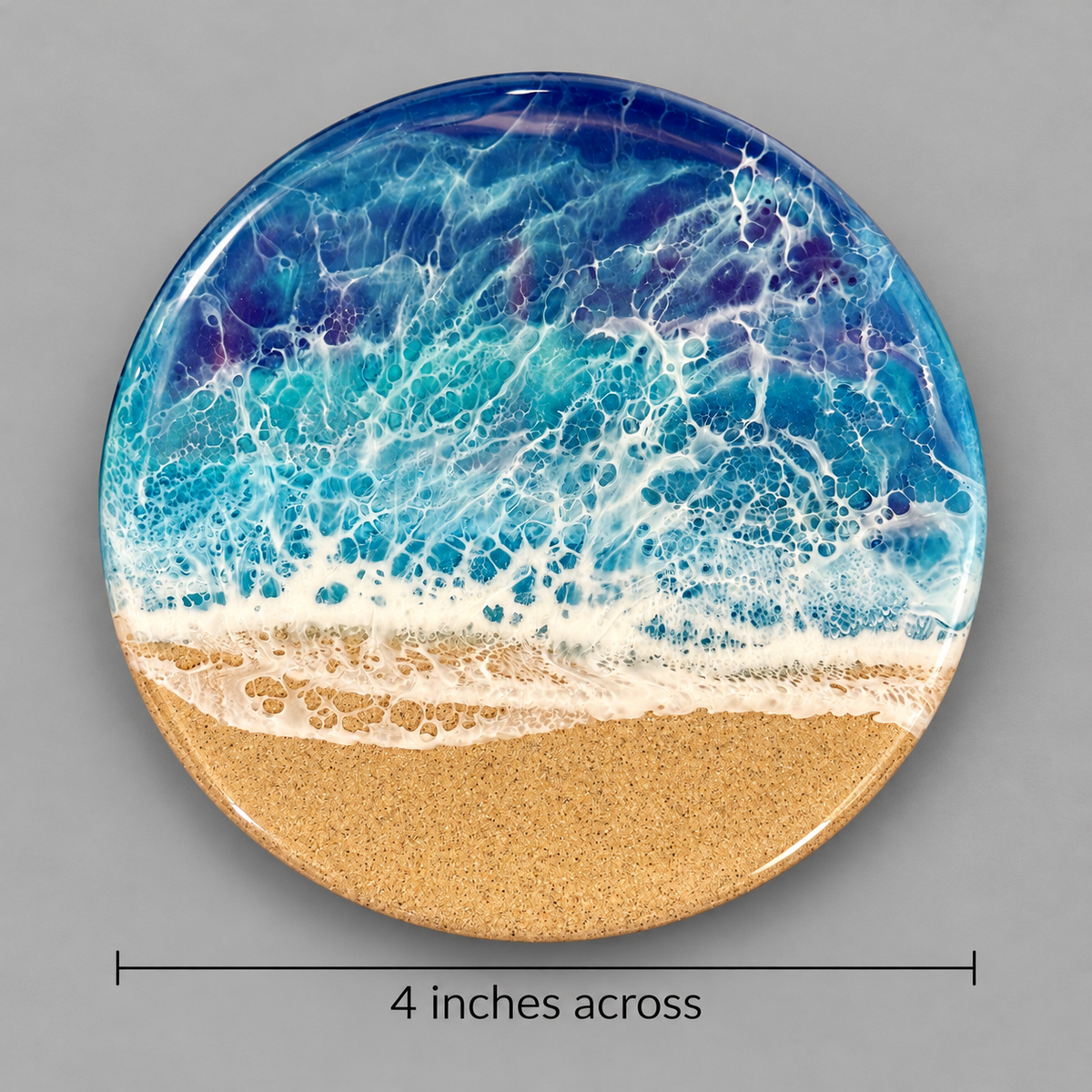 Round resin coasters featuring an ocean wave design with blue and white water and a sandy beige bottom, shown on a gray background with a dimension line indicating 4 inches across.