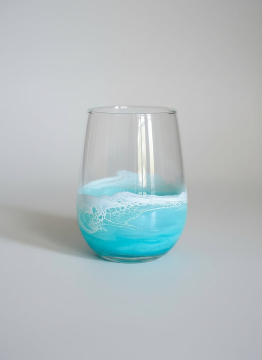 Glass with blue ocean design on a gray background