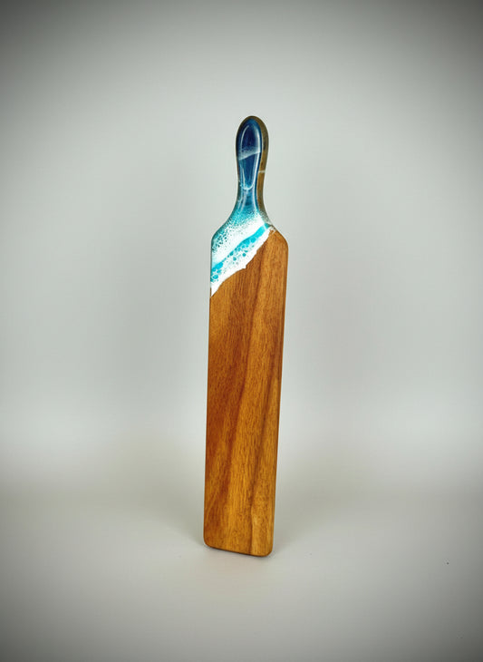 Wooden paddle with blue and teal resin waves bread serving board