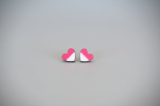 Heart-shaped earrings with pink and white design on a gray background